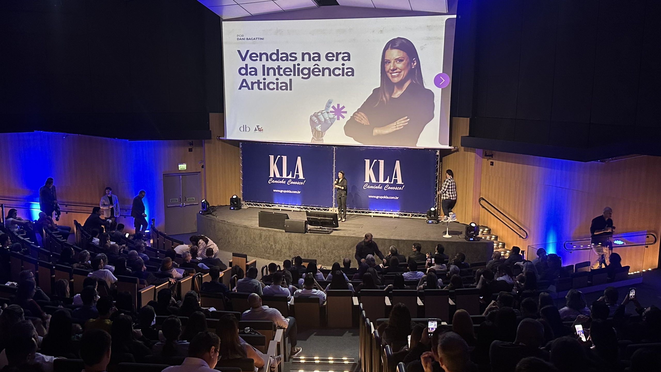 [Foto de Daniela Bagattini palestrando no palco do CNV 2025.]